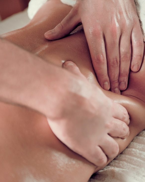 Therapist applying focused deep pressure massage to the back